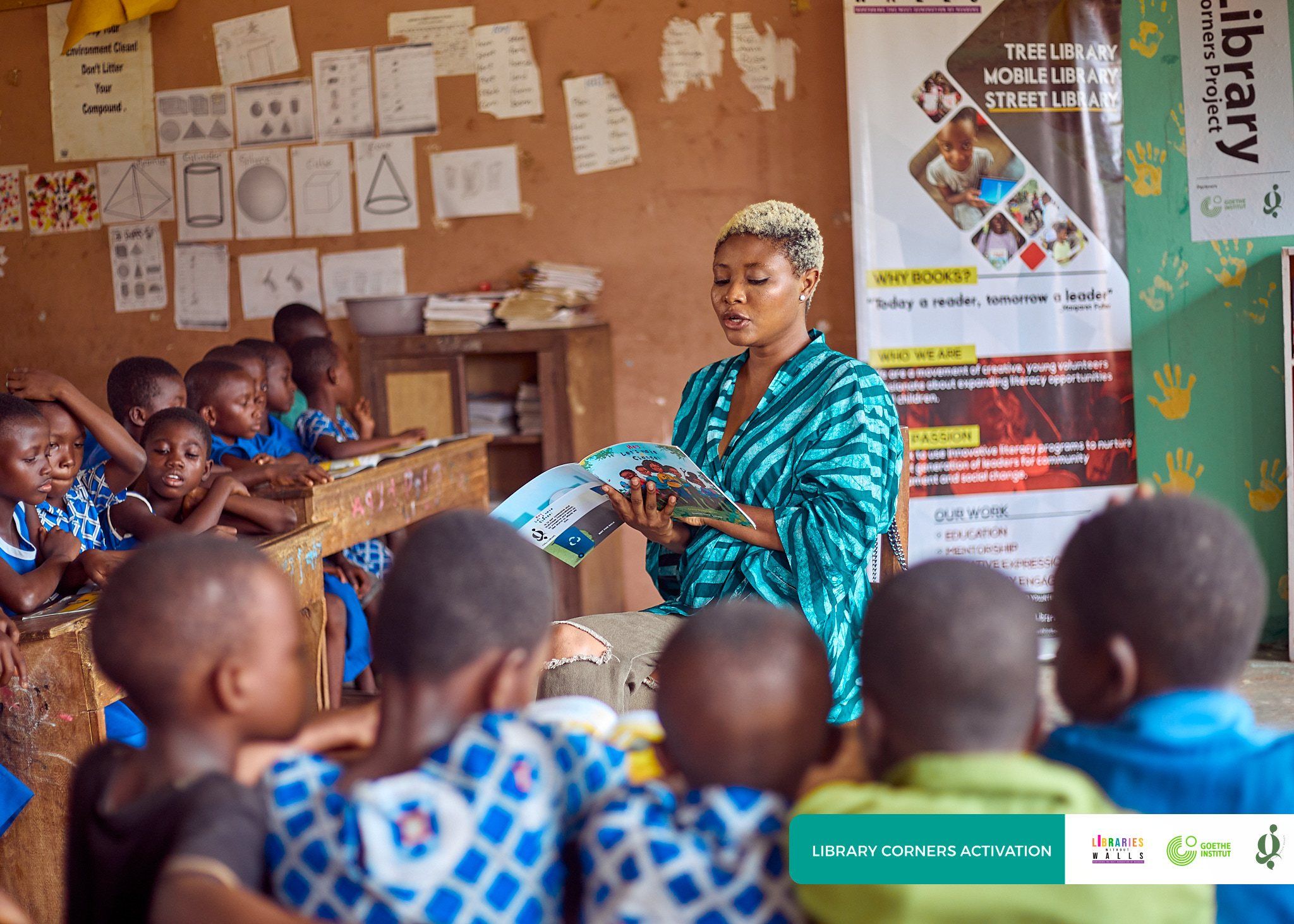 A volunteer reading a story aloud to a classroom of children