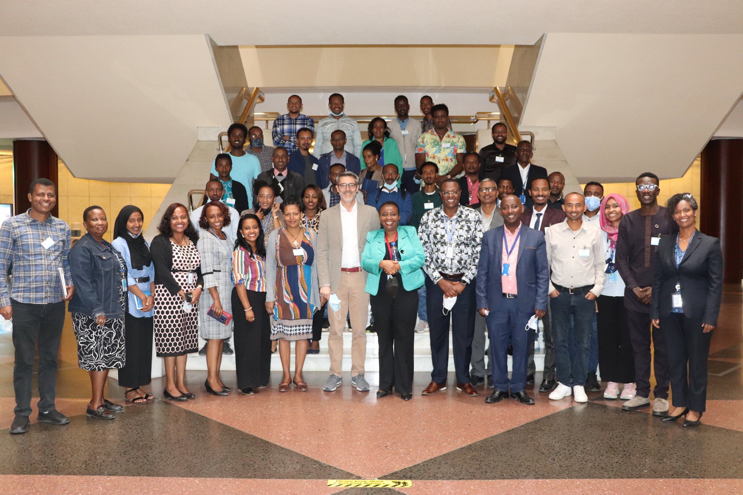 Workshop participants gathered for a group photo on a staircase